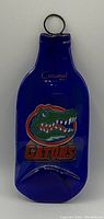 Front view of deep blue glass decorative item with Florida Gators logo and Cozumel etching.