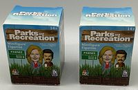 Two sealed boxes of Parks and Recreation minifigure figurines, Series 1 Pawnee set, featuring cartoon character depictions and the series branding.
