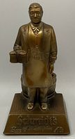Front view of Schmidt's ale beer statue showing a man holding two mugs of ale with 'Schmidt's Beer of Philadelphia' engraved on base.