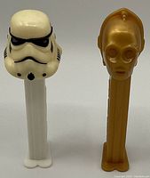 Photo showing two vintage Star Wars PEZ dispensers, one Stormtrooper and one C-3PO, both used condition.