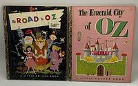 Two Little Golden Books in the Wizard of Oz series: The Road to Oz and The Emerald City of Oz, showing front covers with classic illustrations.