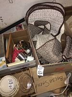 Top view of box containing floral-patterned fabric covers folded and stacked.