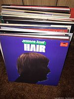Photo showing collection of vinyl records with James Last 'Hair' album on top.