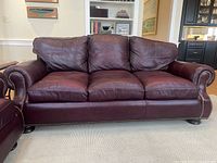 Front view of three-seat burgundy leather couch