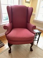 Front view showing full chair upholstery, seat, and carved wooden legs