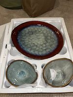 Large oval plate and two small bowls in foam packaging