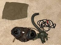 Full lot showing headphones, oxygen mask, cord, and carrying bag on carpeted floor.
