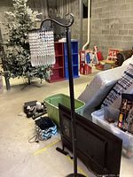 Full view of floor lamp showing curved metal stand and base with crystal pendant shade hanging.