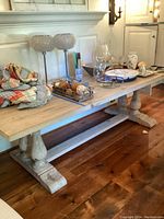 Full view of table top and base, showing decorative items on surface