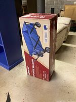 Boxed Quest Folding Sports Wagon showing front side of the box with product image and brand name.