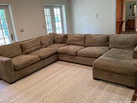 Overall view of L-shaped sectional sofa in room