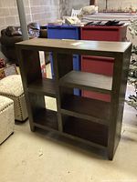 Full front view of the multi-tiered wooden bookcase showing six open compartments and dark wood finish.