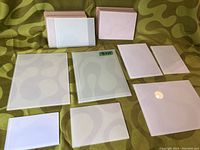 All 17 frosted or white glass panels laid out on fabric background, showing variety of sizes and shapes including small rectangles and squares
