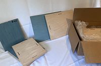 Wood photo panels showing front covered with protective blue film and back with mounting slots. Several panels labeled with sizes 8 x 10.