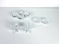 Three sets of glass candle holders: two 9-point crystal star shapes, two shell-shaped clear glass holders, and a four-candle Dorre glass holder