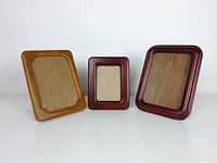 Front view of three teak wood photo frames showing different sizes and finishes.