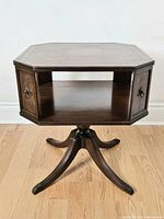 Full view of the octagonal barrister's side table showing solid mahogany wood, octagonal shape, side compartments with metal ring pulls, open shelf, and Duncan Phyfe style pedestal base.