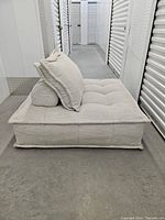 Front view of seat module with back cushion at left side