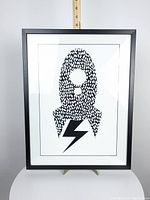 Front view of black framed rocket wall art print showing full artwork and frame.