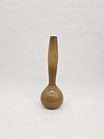 Front view of the vase showing its tall, elongated gourd shape with glossy brown finish on a white background.
