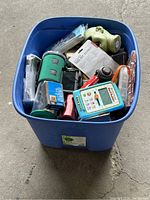 Blue plastic bin filled with assorted items