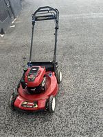 Front angle view of the red Toro Recycler 22 lawnmower with black handle and personal pace label.