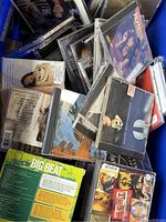 Blue bin filled with assorted vintage music CDs with visible album cover art