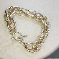 Image showing the full bracelet with toggle clasp closed, highlighting the chain link style and polished finish.