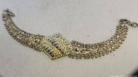 Handmade antique bracelet shown in full, displaying intricate metalwork and beaded details.