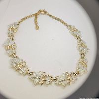 Full view of the vintage Sarah Coventry leaf necklace showing linked leaf elements and gold-tone chain with clasp