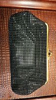 Front view of the black beaded clutch purse with gold-tone metal frame.
