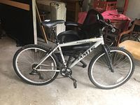 Side profile of whole Jamis Ranger XR bicycle showing frame, tires, seat, and handlebars in a garage setting.