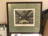Framed print showing the full artwork and matting, with a wooden frame and green mat.
