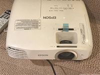 Front view of Epson projector showing lens and ventilation grille