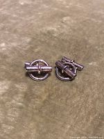 Pair of sterling silver Hermès cufflinks showing circular design and bar toggle backs.