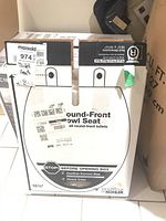 Boxed Kohler round-front toilet seat with label indicating size and seat type.