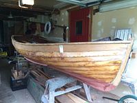 Starboard side view of hull showing lapstrake construction and bright finish