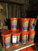 Shelf containing 13 bright orange sealed Fox 40 Boat Essentials Safety Kits clearly labeled with brand and usage instructions.