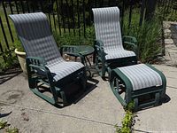 Two glider chairs, ottoman and side table on patio