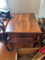 Top angled view showing the wooden surface, drawer and leg design of the Gibbard end table.