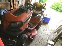 Front three-quarter view of entire tractor showing deck, steering wheel, seat.