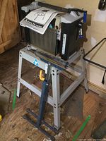 Front view showing planner mounted on steel stand with roller support in front