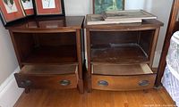 Pair of wooden side tables with drawers open showing interior and items on top removed.