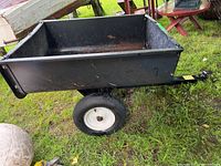 Side view of black poly composite bed on steel frame with single wheel