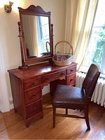 Full view of vanity, mirror and chair placed together