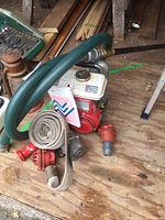 Overview of water pump assembly with hoses and fittings on wooden surface