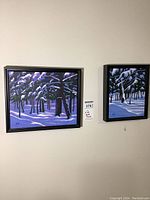 Two framed paintings on wall showing snow-covered pines under moonlight with shadow play, signed Yates, sizes approximately 12x10 and 8x10 inches