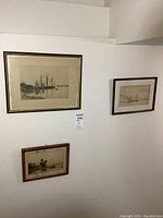 View of all three framed nautical artworks mounted on a white wall, showing relative sizes and frames.