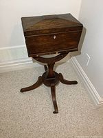 Front view of wooden box on turned pedestal base with beaded trim.