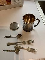 Overview of six silver items: cup, compact, two forks and two spoons